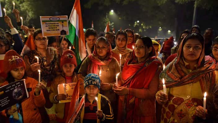 CRPF soldiers' family members hold candles 