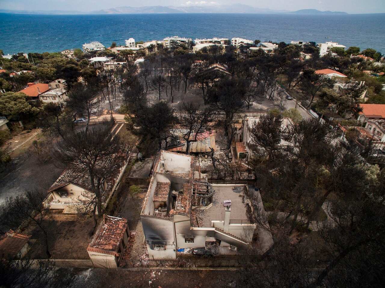 An aerial view shows burnt houses following a wildfire in the village of Mati, near Athens.