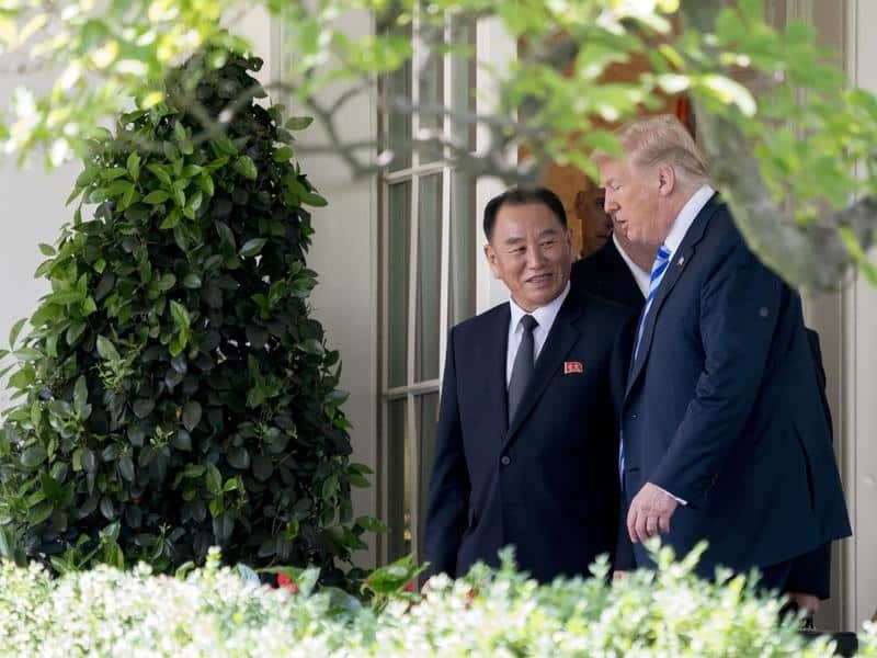 President Donald Trump talks with North Korean envoy Kim Yong Chol