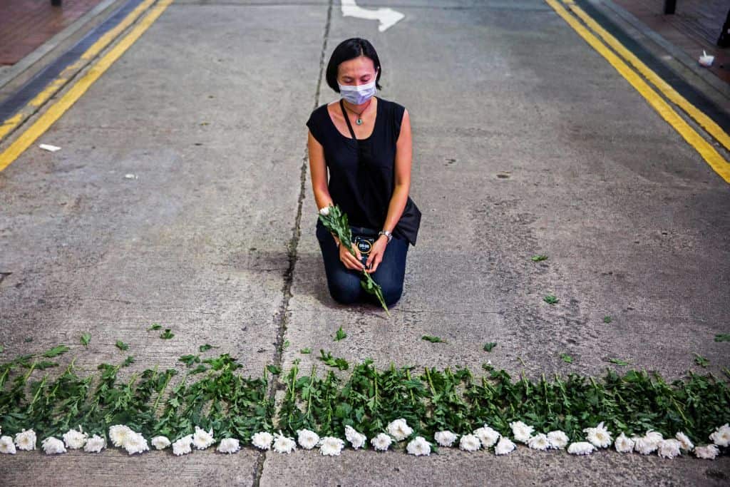 An artist takes part in a performance art in the Causeway Bay district of Hong Kong on 3 June, 2021, to mourn the victims of China's Tiananmen Square crackdown.