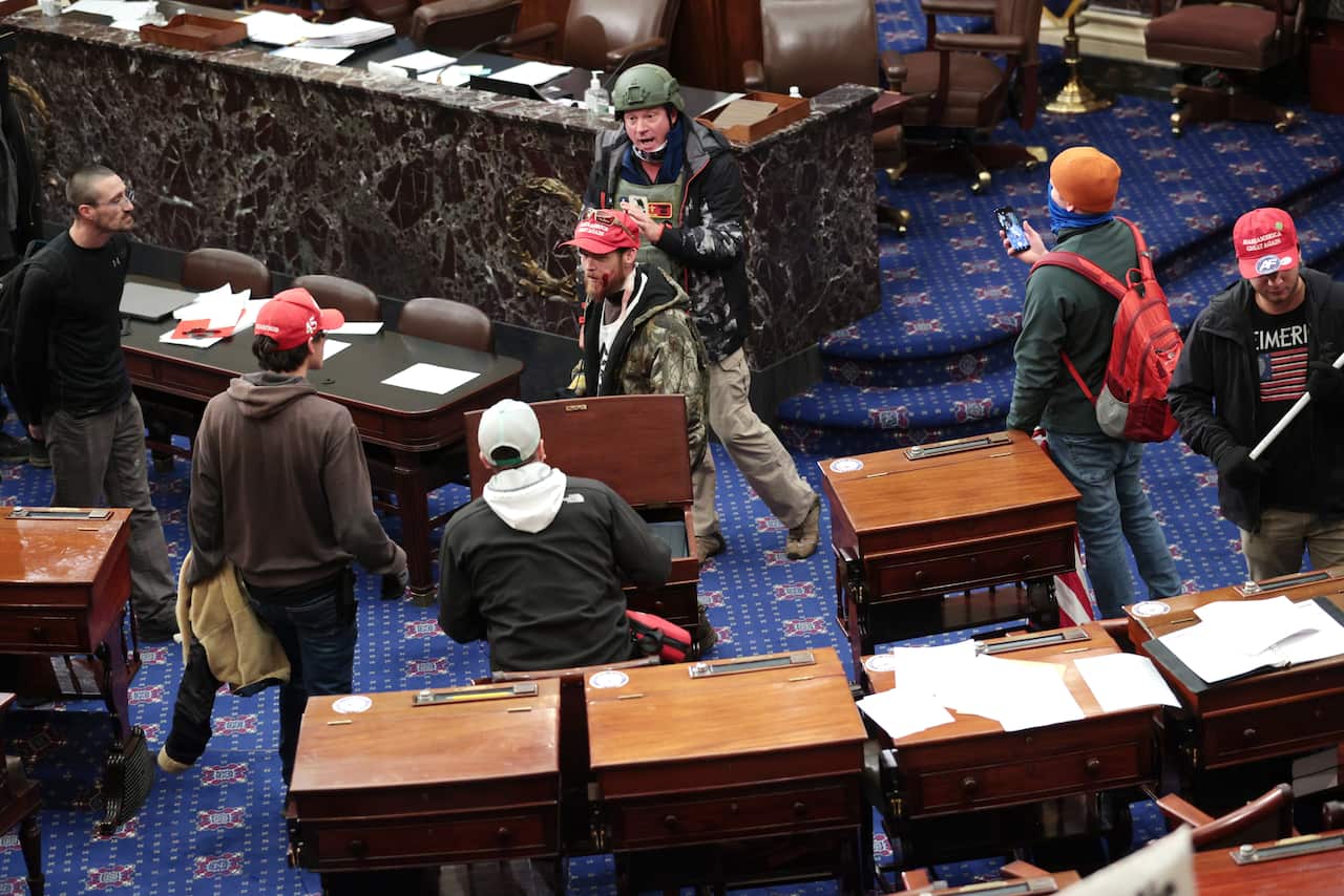 Protesters enter the Senate Chamber.