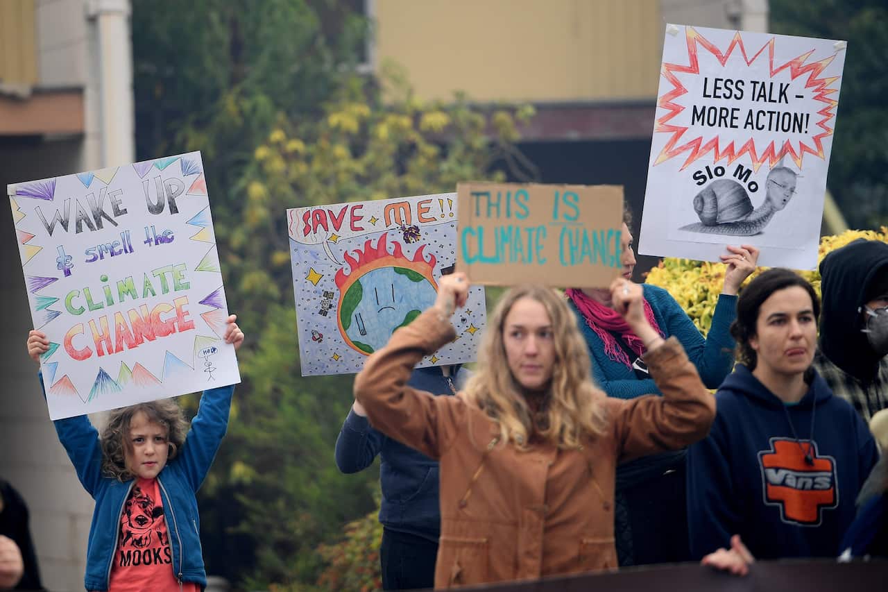 Protesters rally outside as NSW Premier Gladys Berejiklian meets with Rural Fire Service Deputy Commissioner Rob Rogers at the Blue Mountains Fire Control Centre in Katoomba, Monday, December 23, 2019. (AAP Image/Dan Himbrechts) NO ARCHIVING
