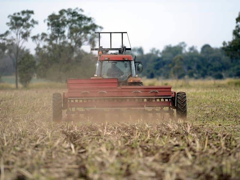 A farmer sows barley on his farm.