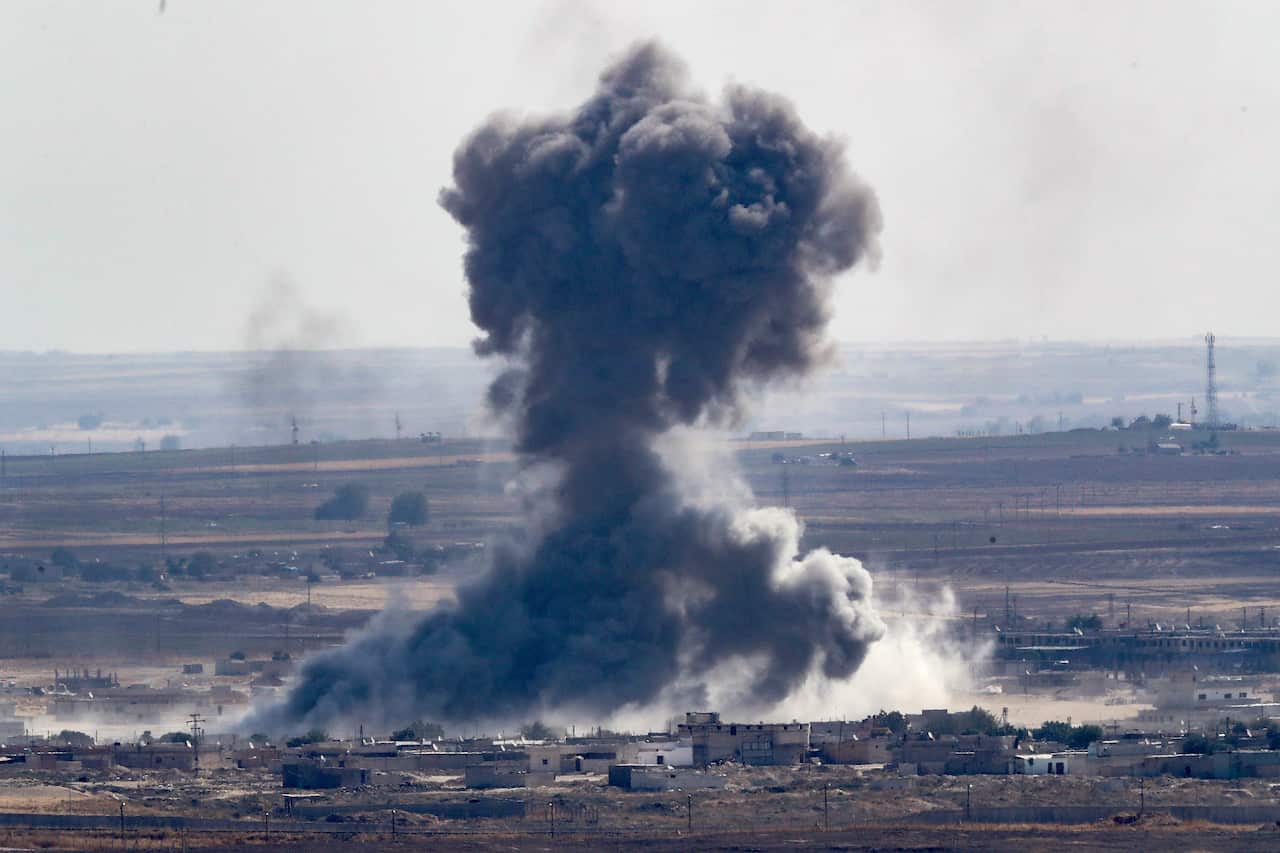 Smoke rises over the Syrian town of Ras al-Ain, as seen from the Turkish border town of Ceylanpinar.