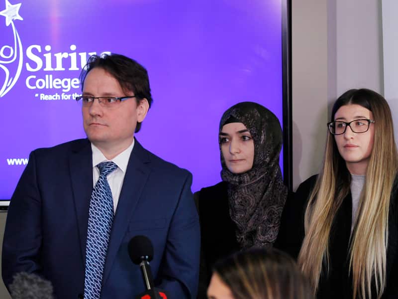 Sirius College staff at a press conference
