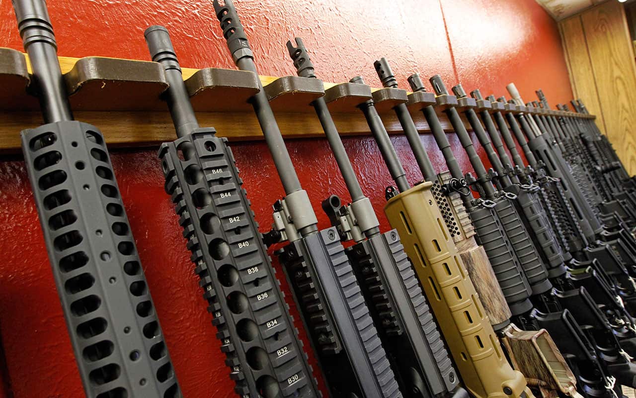 A row of different AR-15 style rifles are displayed for sale at the Firing-Line indoor range and gun shop in Aurora, Colorado.