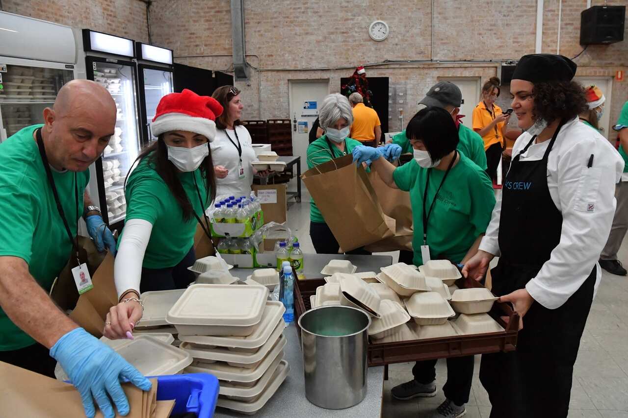 Volunteers pack free meals for Christmas lunch for the homeless and needy at the Reverend Bill Crews Foundation at Ashfield in Sydney.