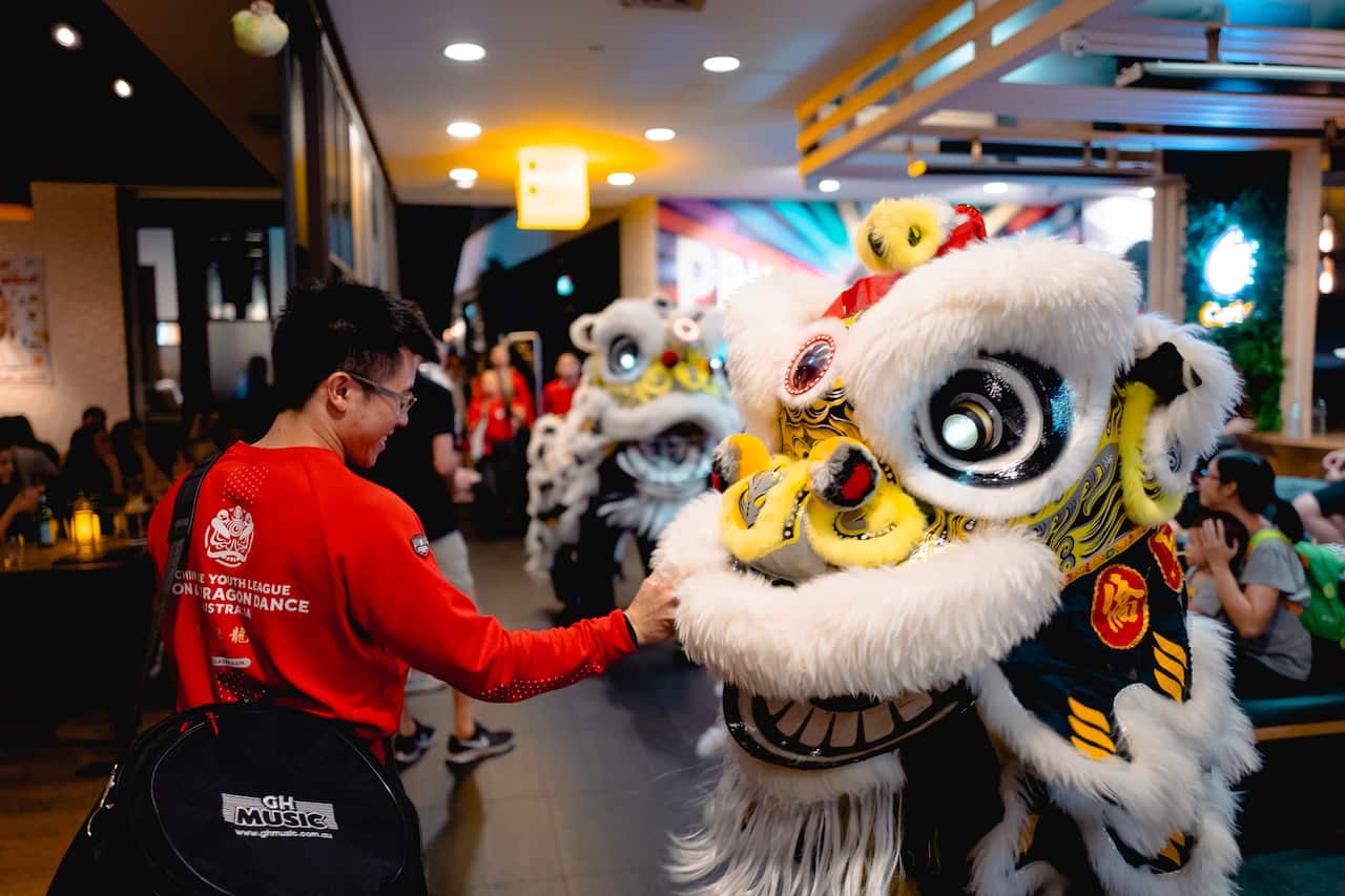 Lokman Leung with a dragon dancing costume. 