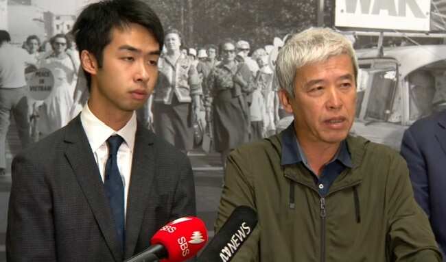 Migrant worker Xueliang Wang (r) speaks to media.