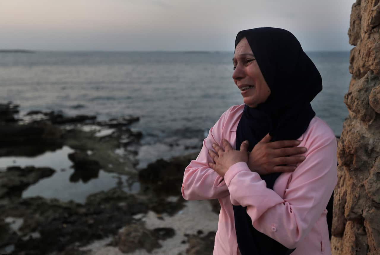 Afaf Adulhamid, whose son Mohammed Khaldoun, 27, went missing at sea as he tried to reach Cyprus, cries and prays for his return on the coast of Tripoli city.