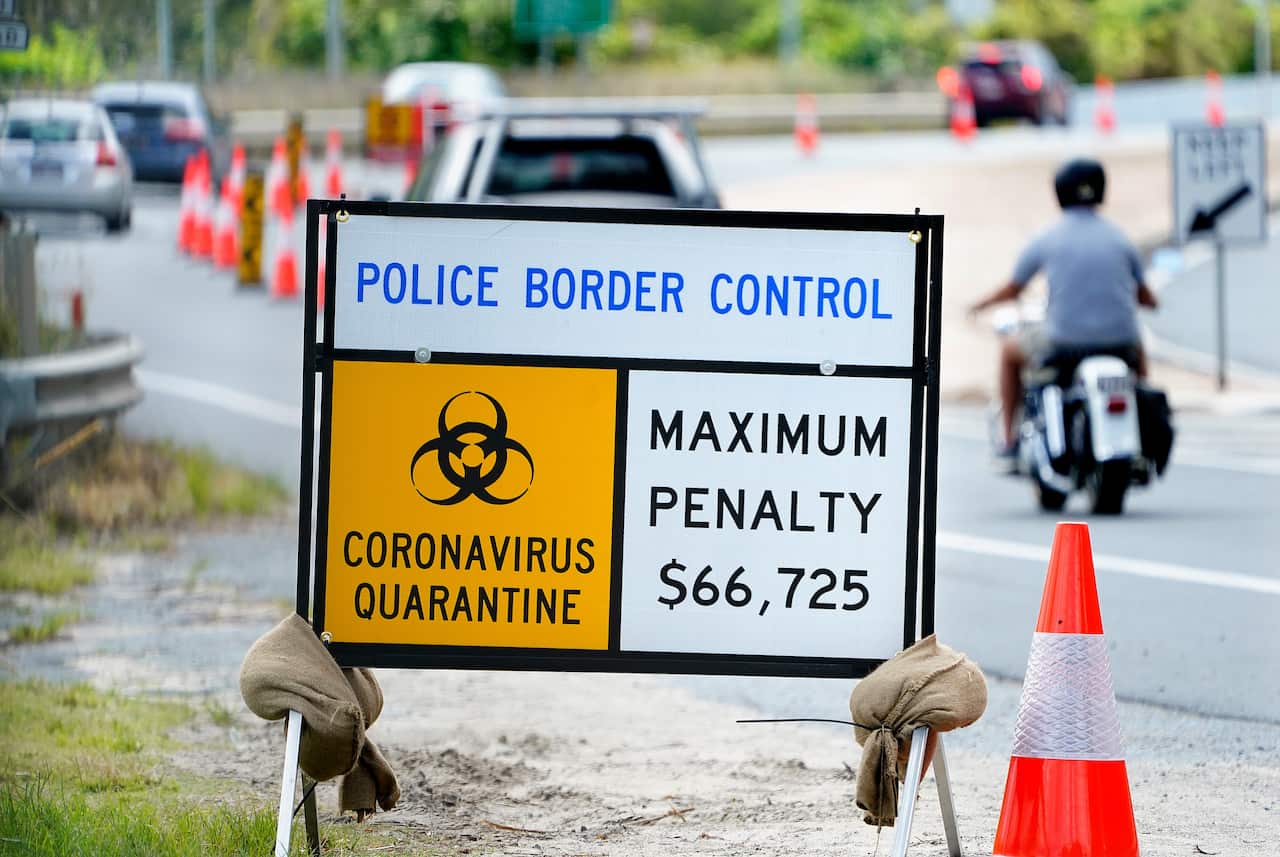 Border control signage is seen as motorists approach the Queensland - New South Wales border at Currumbin on Gold Coast. 