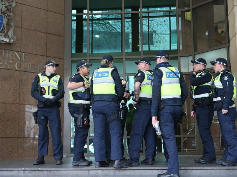 Victoria Police officers outside the Melbourne Magistrates Court
