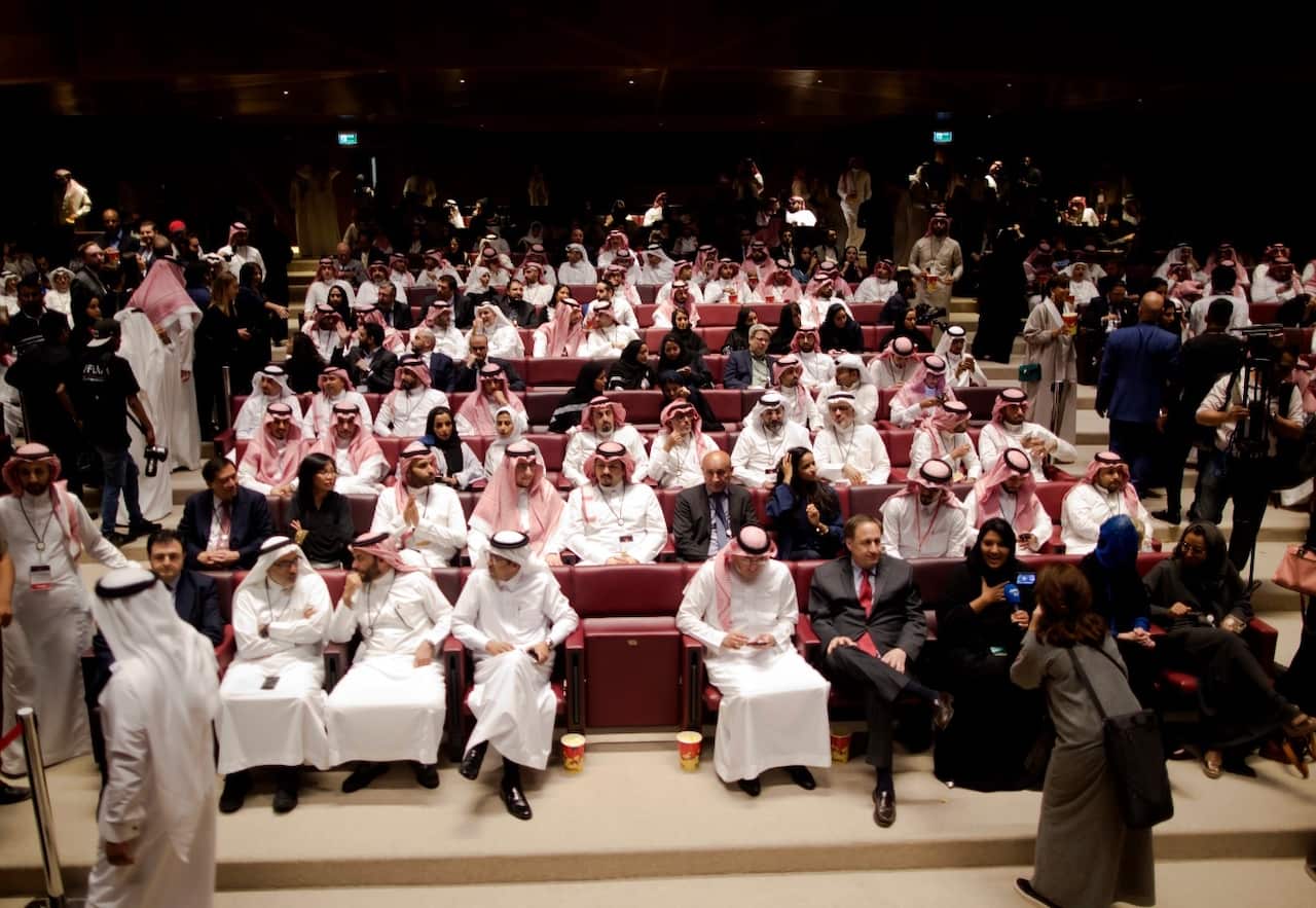 Visitors attend a cinema theatre during an invitation-only screening, at the King Abdullah Financial District Theater