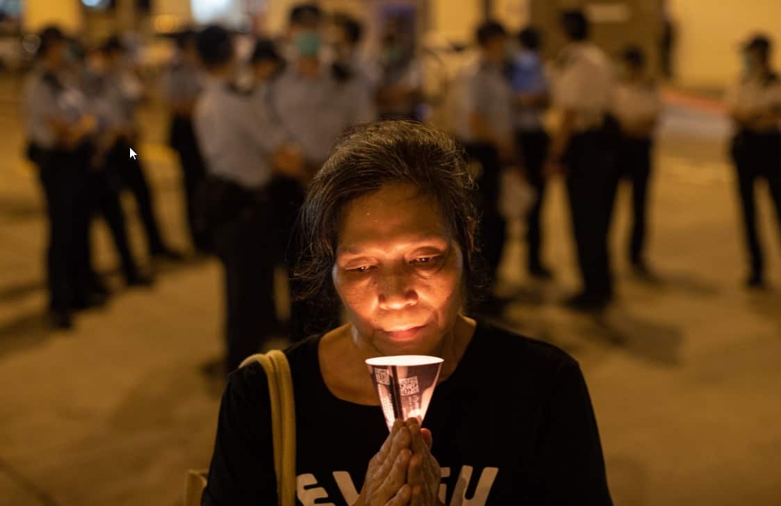 A woman holds a candle on the eve of the Beijing Tiananmen Massacre anniversary in Hong Kong