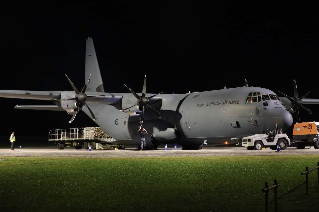 A RAAF Hercules is unloaded of supplies after arriving at Christmas Island. 