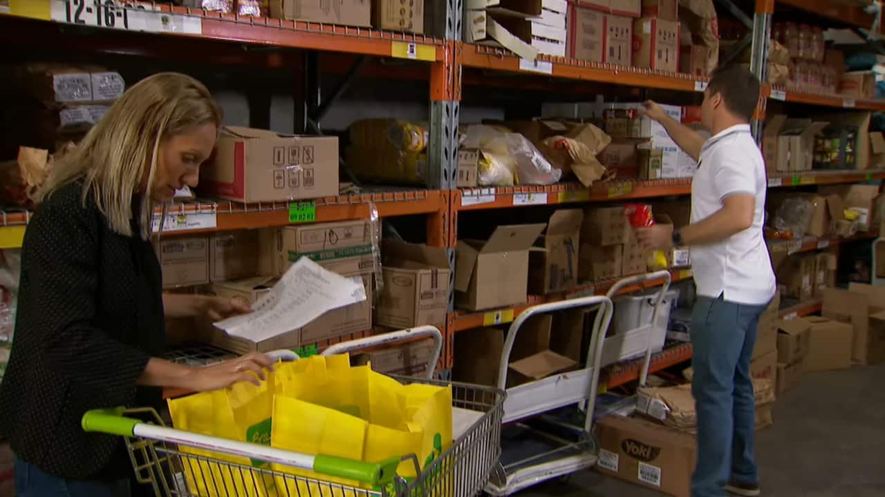 Ana Ferreira and Jason Hill check stock in their warehouse which contains cooking equipment from Brazil.