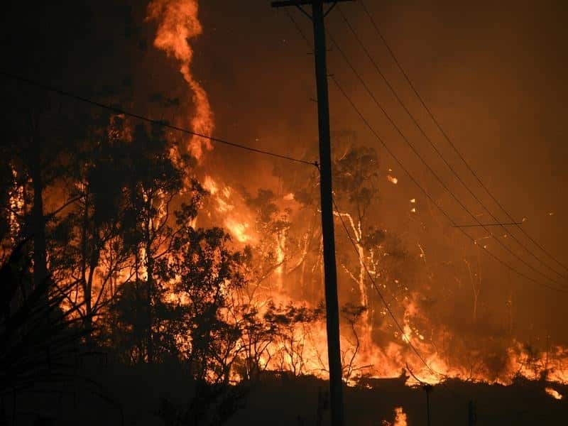 Bushfire crews watch a fire north of Sydney.