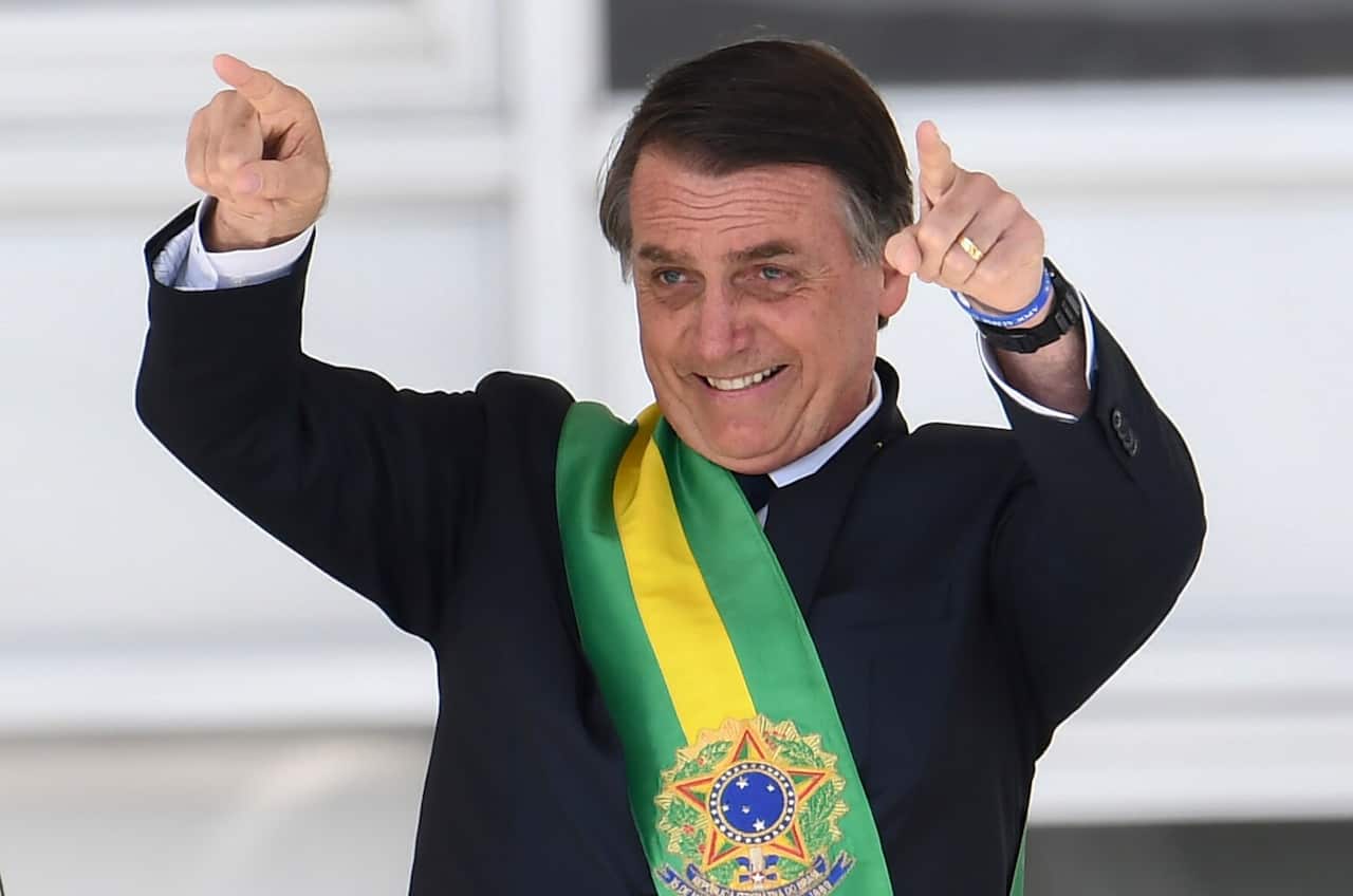 Brazil's new president Jair Bolsonaro gestures after receiving the presidential sash.