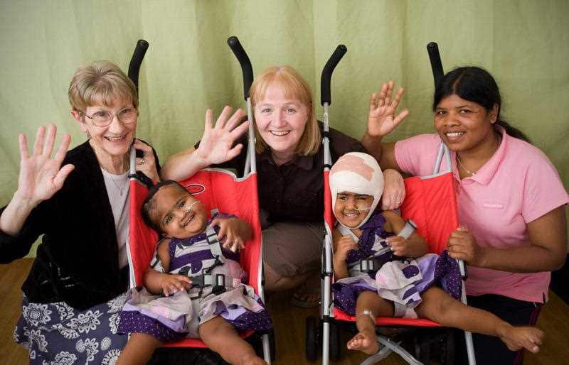 Supplied photo of Krishna (left) and Trishna (right) with (L-R) Sister Fran, Moira Kelly and Maria Mardi from Children First Foundation shortly before the twins were released from the Royal Children's Hospital in Melbourne on Monday, Dec. 21, 2009.