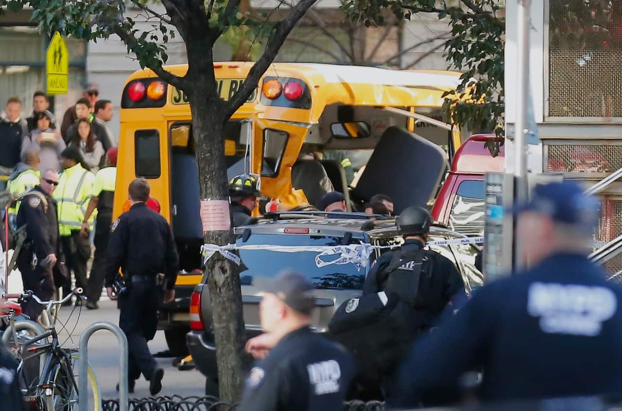 Authorities respond near a damaged school bus Tuesday, Oct. 31, 2017, in New York.