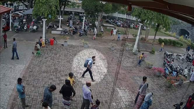 The footage shows a man wearing a large backpack calmly walking towards St Sebastian's church.