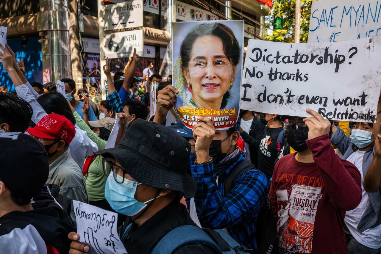Protesters hold images of de-facto leader Aung San Suu Kyi on 10 February, 2021 in Yangon, Myanmar.