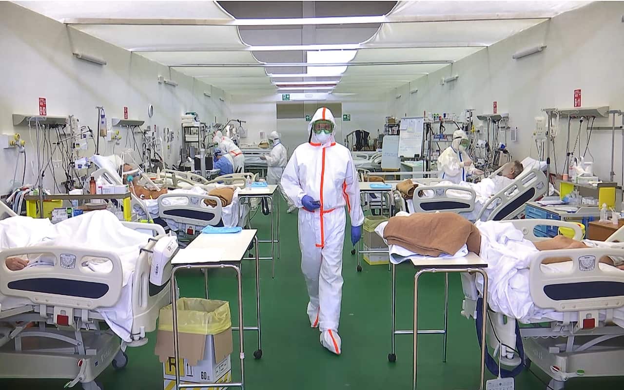 Medical staff in protective gear in an intensive care unit in a field hospital in Bergamo, Italy.