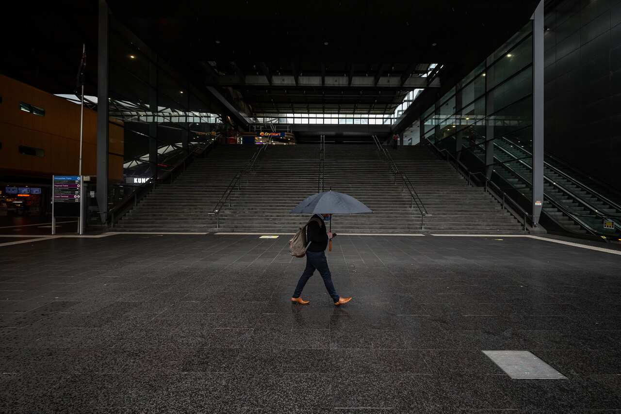 A person walks past a quiet Southern Cross Station in Melbourne.