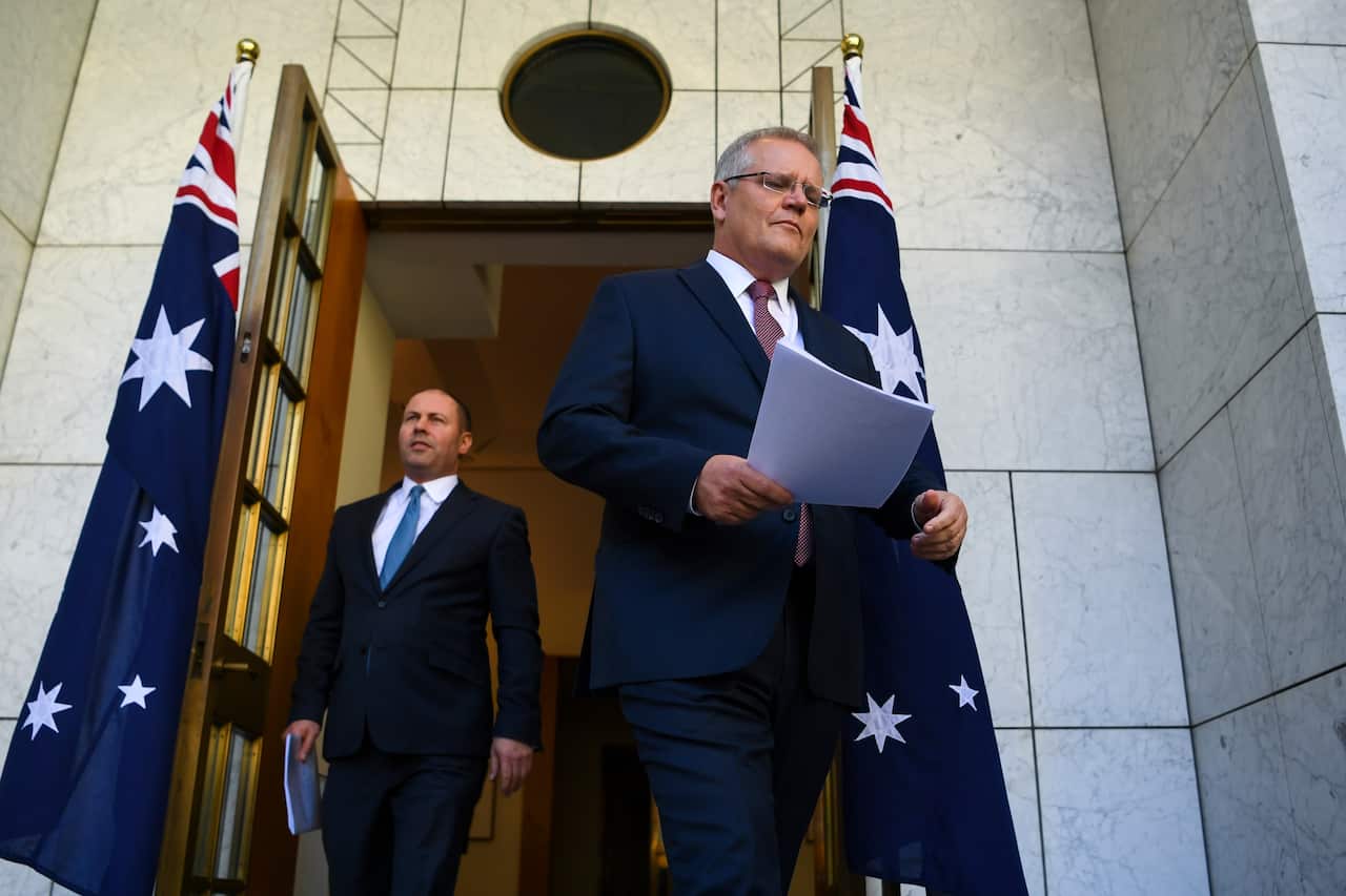 Australian Prime Minister Scott Morrison and Australian Treasurer Josh Frydenberg arrive to speak to the media during a press conference at Parliament House in Canberra, Friday, March 20, 2020. (AAP Image/Lukas Coch) NO ARCHIVING