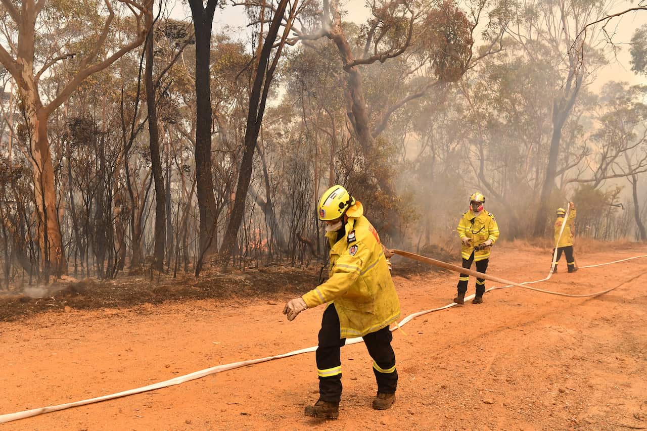 New South Wales Rural Fire Service (RFS) and Fire and Rescue NSW (FRNSW) battle the Gospers Mountain fire.