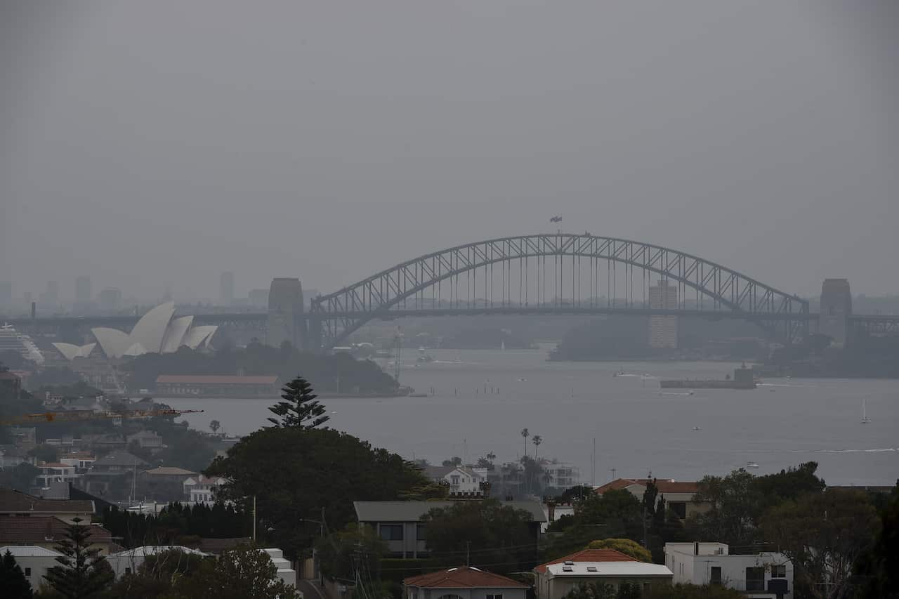The Sydney Opera House and Harbour Bridge are seen through smoke haze from bushfires in New South Wales.