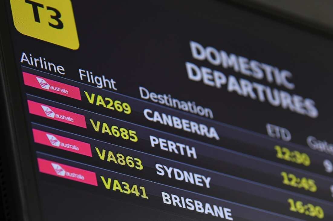Electronic signage for Virgin Australia domestic departure flights is seen at Tullamarine Airport, Melbourne, Tuesday, April 21, 2020. 