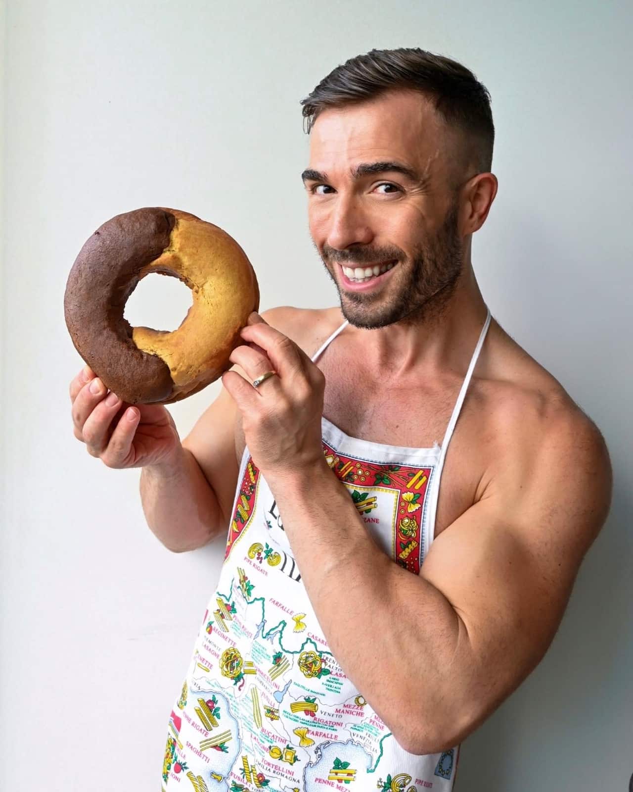 Dan Pasquali holding a massive Abbraccio biscuit.