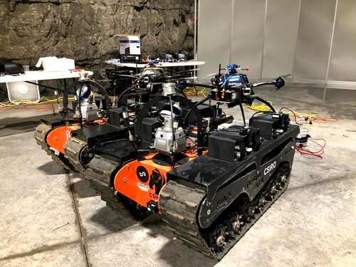 Two of team CSIRO's Data61's all terrain tracked robots, each with aerial robots mounted on top
