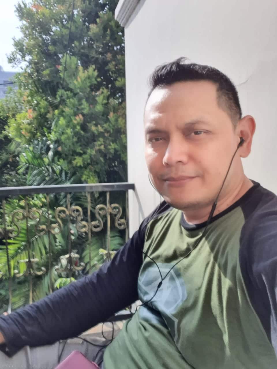 Masbukhin Pradhana on his sixth day following his fever, sitting on the balcony of his bedroom to catch a fresh air.  He was still in self-isolation, Sep 2020.  