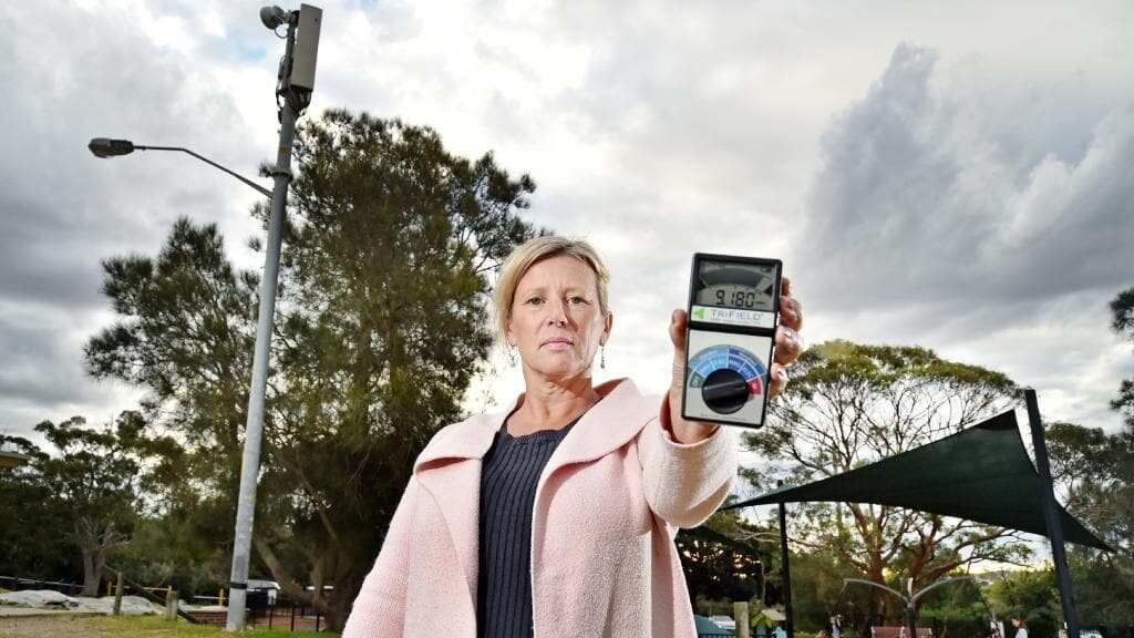 Vivian Dunstan holds an electromagnetic wave detector at Tania Park, Balgowlah. Residents are concerned about the possible dangers of 5G.