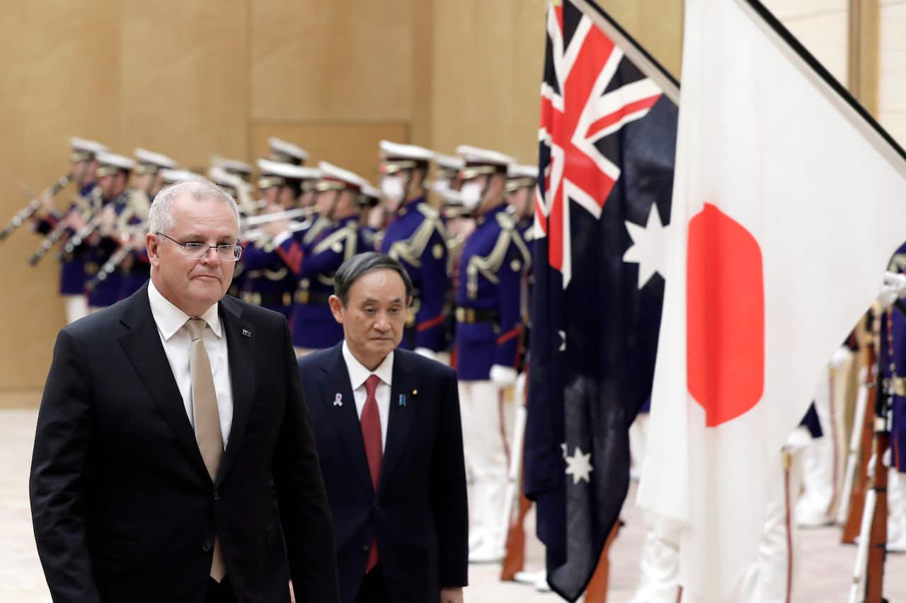 Australian Prime Minister Scott Morrison and Japan's Prime Minister Yoshihide Suga observe an honor guard in Tokyo, Japan, 17 November 2020.