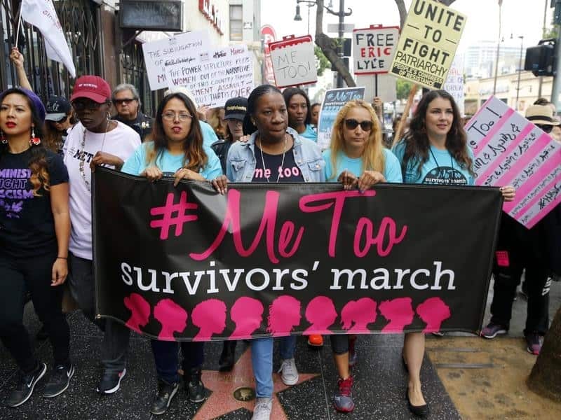 Hundreds of people march in Los Angeles to support victims of sexual assault and harassment. 