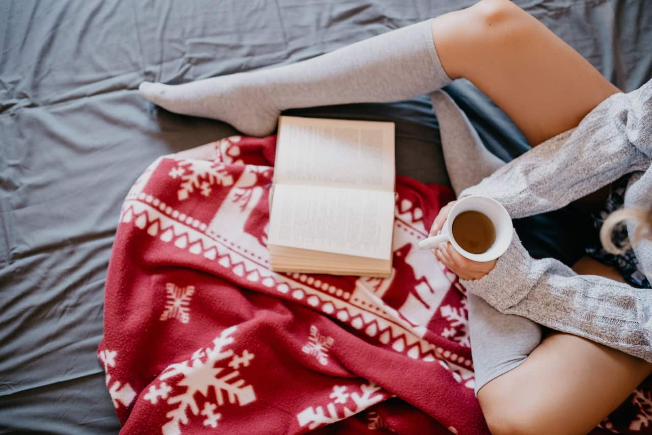 Person reading a book at Christmas