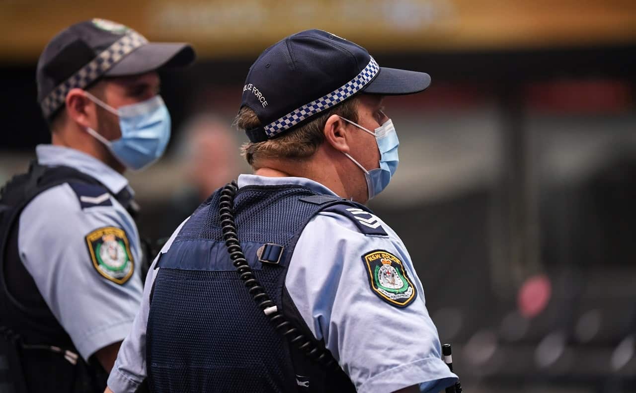 Police officers wear face masks in Sydney.