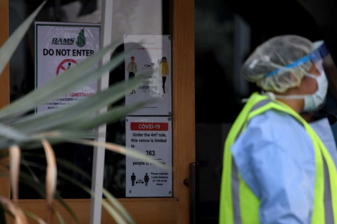 COVID-19 and social distancing signage is seen at the Crossroads Hotel in Sydney, Saturday, July 11, 2020