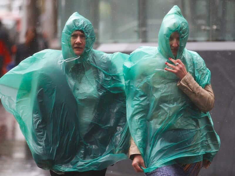 People struggle against the heavy rain