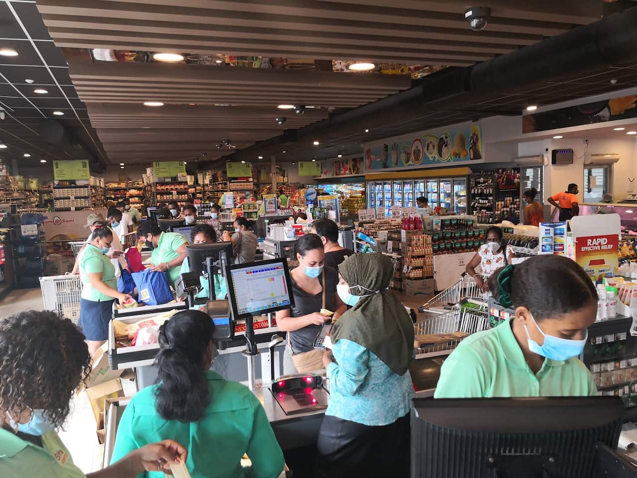 People wearing face masks are seen at a supermarket amid the COVID-19 pandemic in Suva, Fiji, 23 April, 2021.