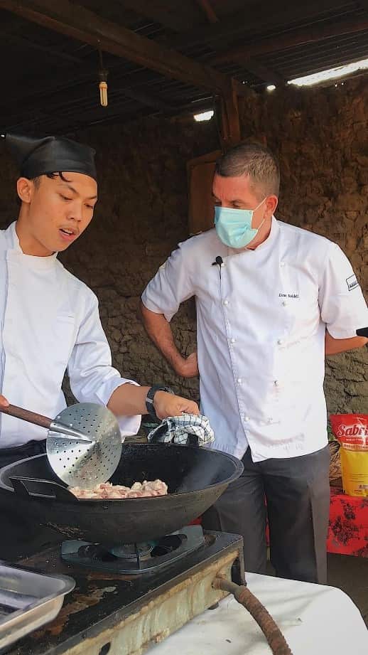 Learning to cook - Dean Keddell and a student 
