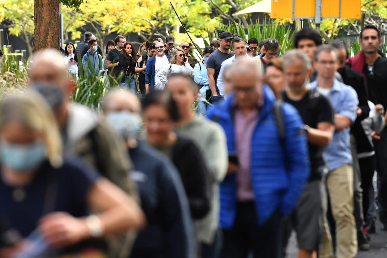 Members of the public wait in line at a mass COVID-19 vaccination hub in Sydney on Monday, 24 May, 2021.