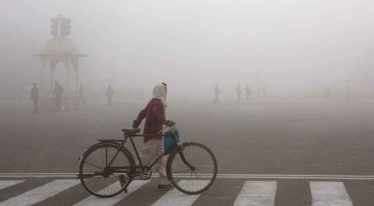This Jan. 18, 2019 file photo shows a cyclist amidst morning smog in New Delhi, India. Beth Gardiner's new book "Choked" documents how air pollution is responsible for seven million premature deaths around the world.