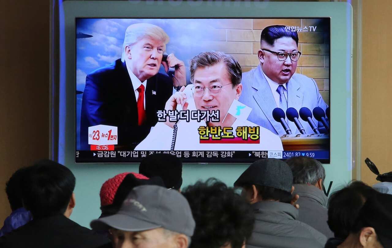 TV screen showing images of North Korean leader Kim Jong Un, right, South Korean President Moon Jae-in, center, and U.S. President Donald Trump 