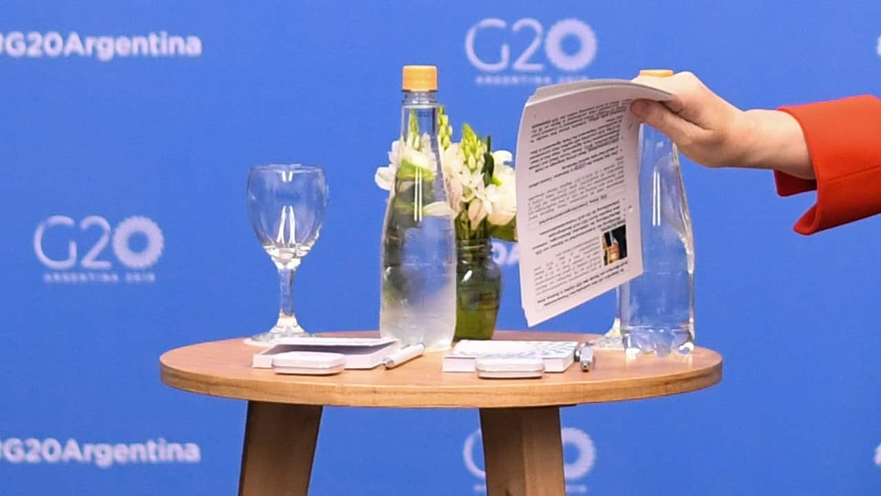 Chancellor of Germany Angela Merkel holds notes with information about her counterpart during a bilateral meeting with Australian Prime Minister Scott Morrison.