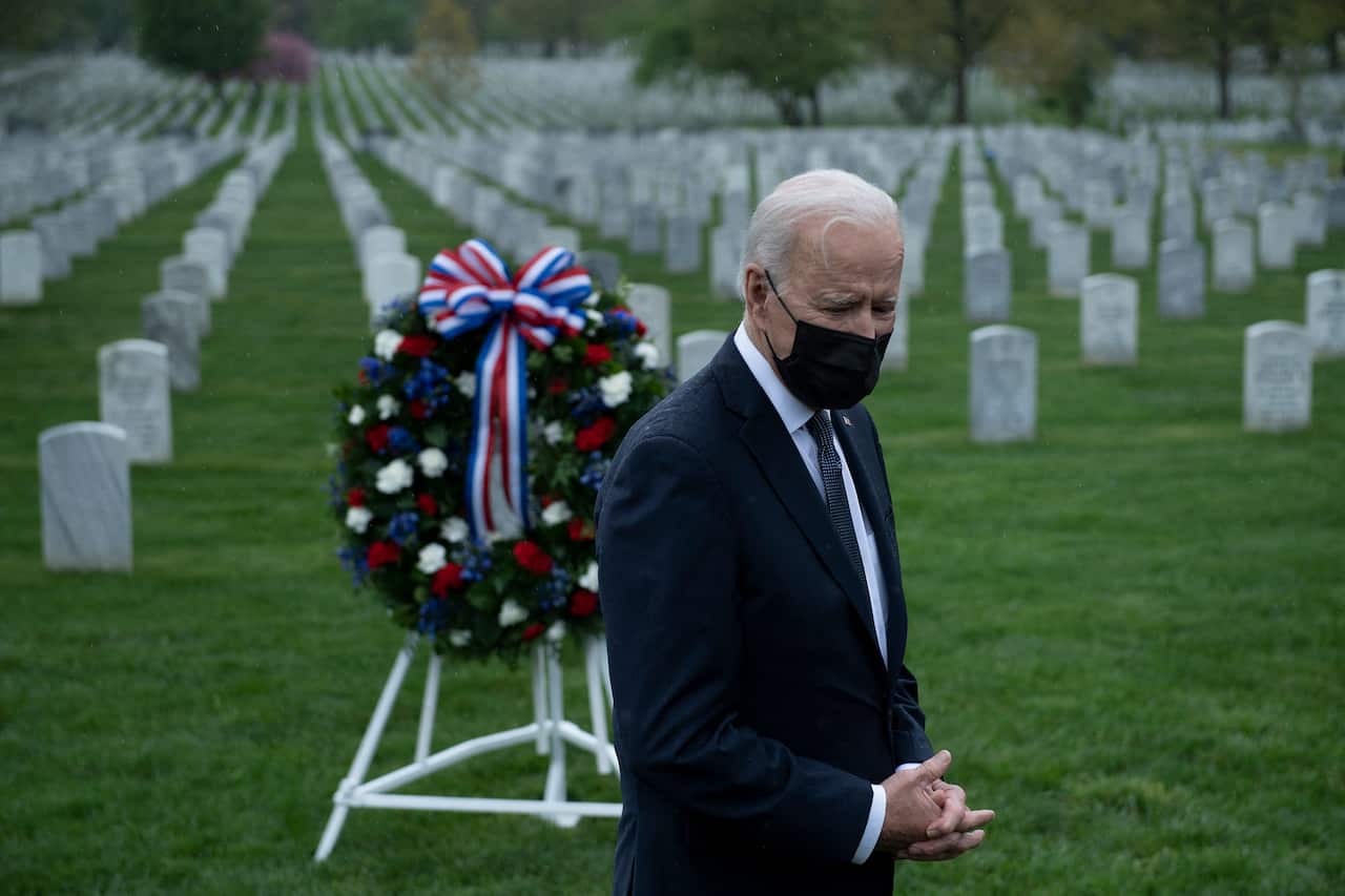 President Joe Biden speaks to the press at Arlington National Cemetery's section 60, where many of those killed serving in Afghanistan are buried,.