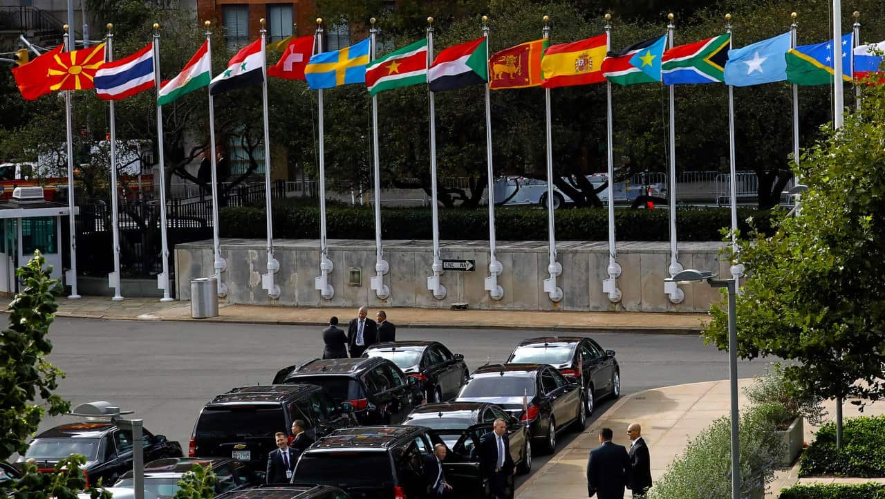 Flags fly above diplomatic vehicles on the first day of high-level meeting at United Nations headquarters in New York on 24 September 2018.  
